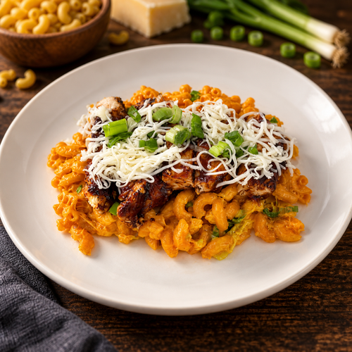 BBQ Chicken Mac n Cheese served on a white plate with ingredients in the background