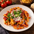 Chicken Parmesan w/Pasta with ingredients in the background